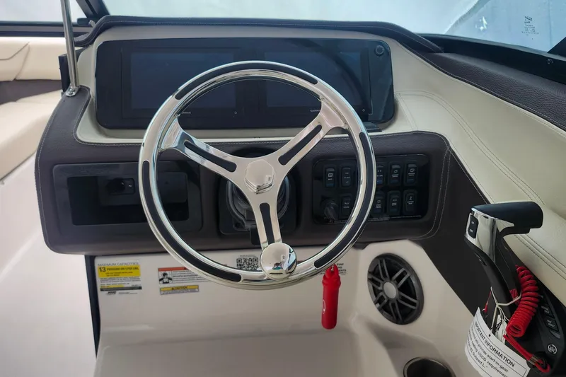 Slide: The Image of Steering console of 2026 Regal LX4 boat with modern controls and sleek design. - 19
