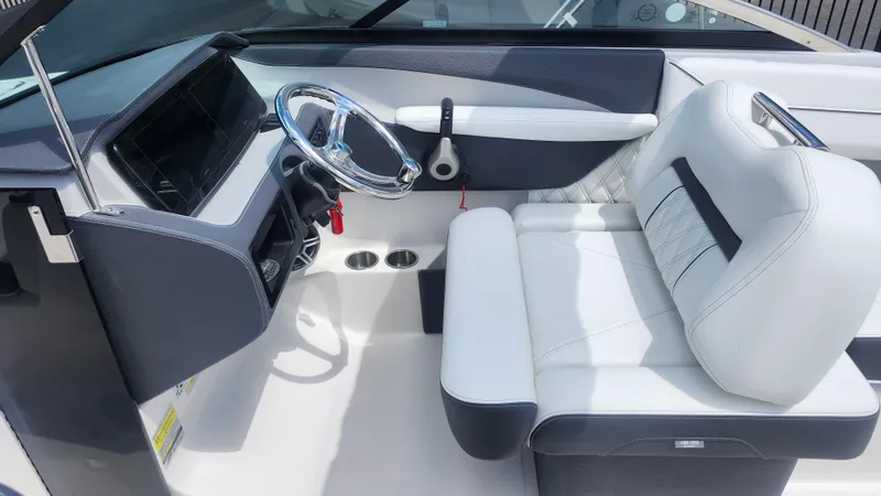 Slide: The Image of 2026 Regal LX4 boat interior with sleek steering wheel and luxurious white seating. - 7