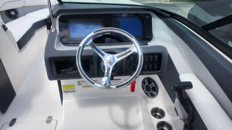 Slide: The Image of 2026 Regal LX4 boat dashboard with steering wheel, touchscreen displays, and control panel. - 8
