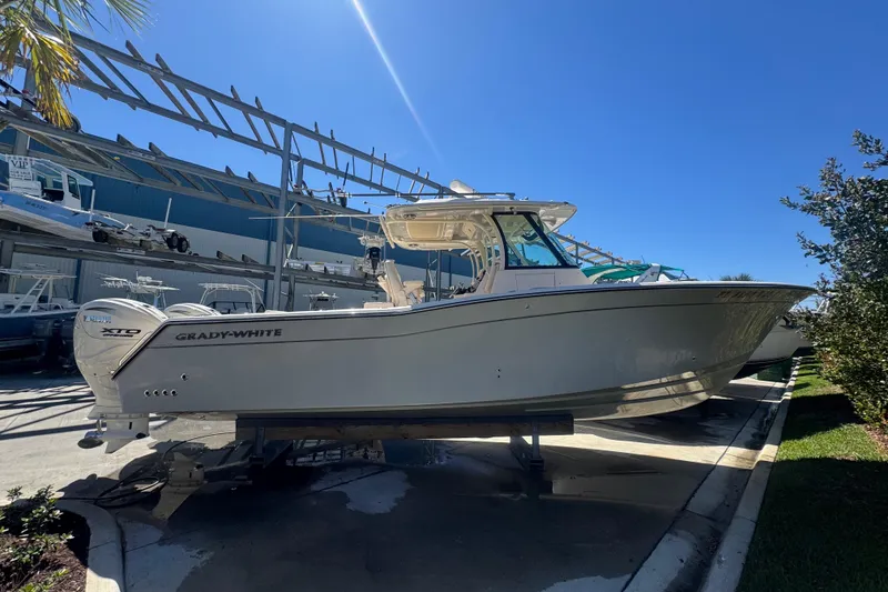 Slide: The Image of 2024 Grady-White Canyon 336 boat displayed outdoors under clear blue sky. - 17
