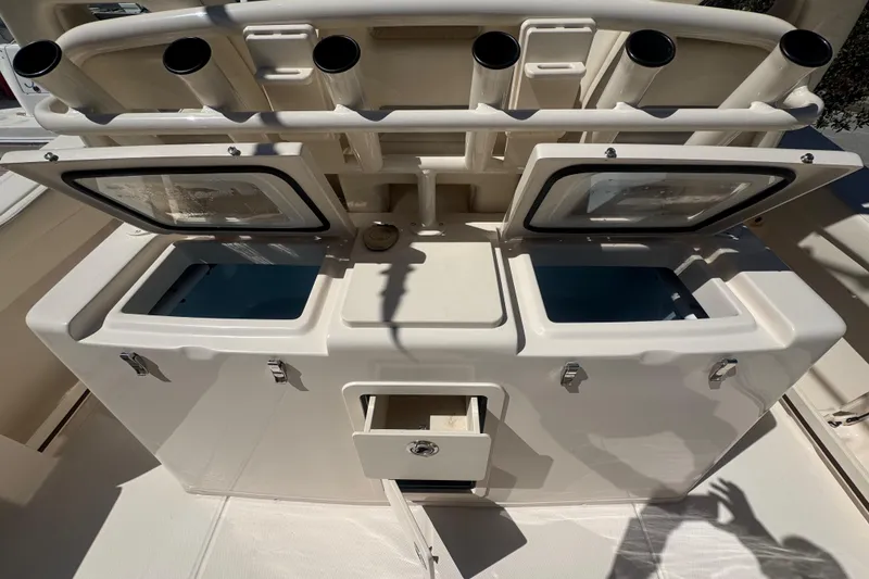 Slide: The Image of 2024 Grady-White Canyon 336 fishing station with rod holders and storage compartments. - 19