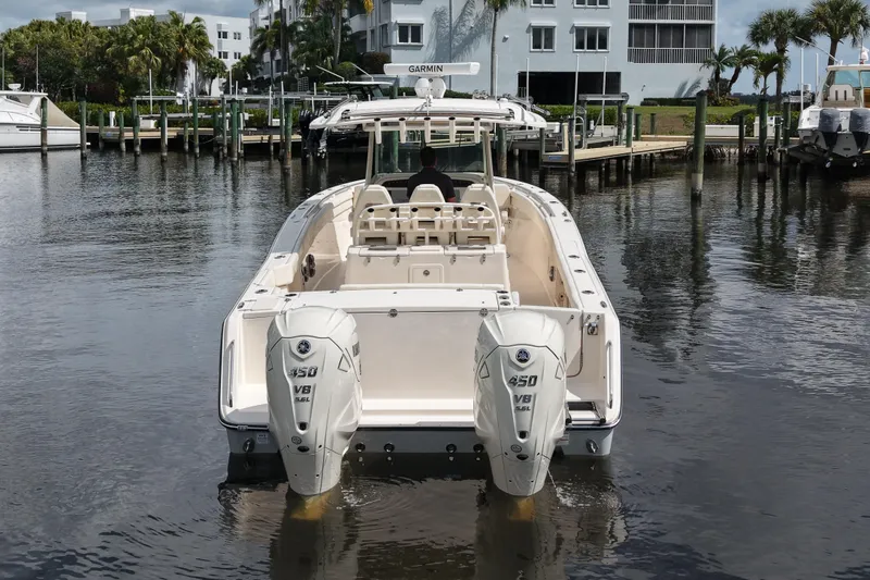 Slide: The Image of 2024 Grady-White Canyon 336 boat with twin 450 V8 engines in a marina setting. - 2