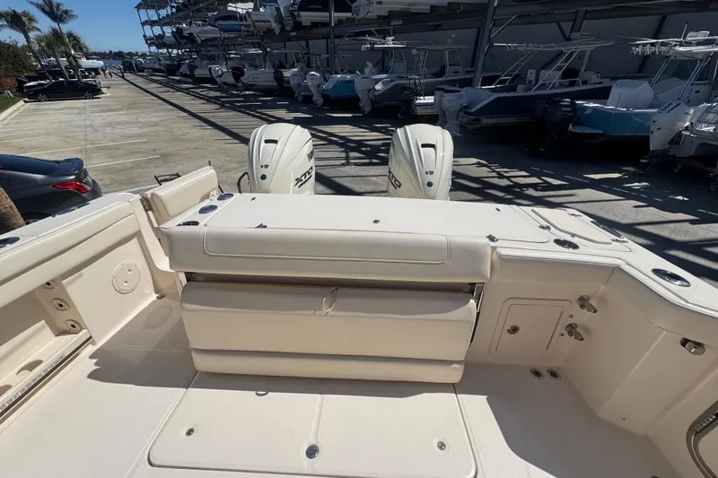 Slide: The Image of 2024 Grady-White Canyon 336 boat interior with dual engines in a marina setting. - 20