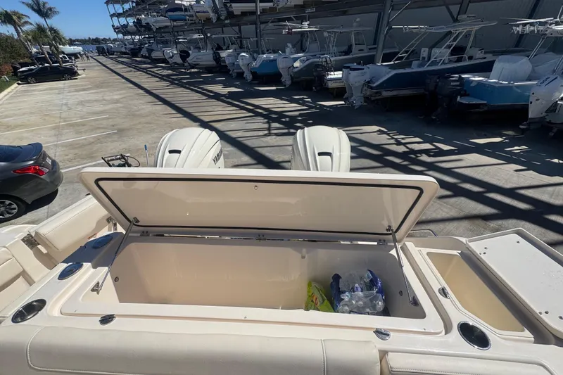 Slide: The Image of 2024 Grady-White Canyon 336 boat with open storage compartment, docked in marina. - 21
