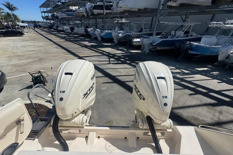 Slide: The Image of 2024 Grady-White Canyon 336 with dual Yamaha V8 outboard engines in a marina. - 23