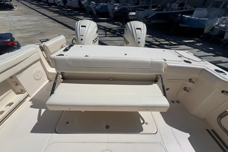 Slide: The Image of 2024 Grady-White Canyon 336 boat interior with foldable seating and dual outboard engines. - 24