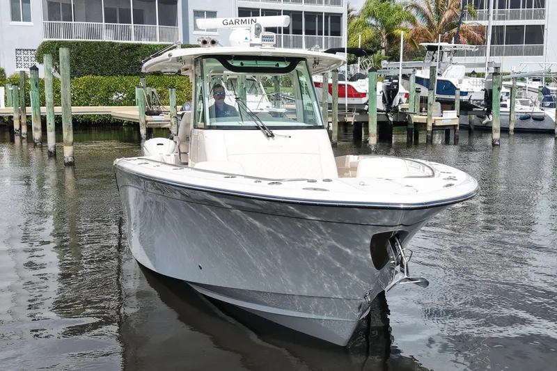 Slide: The Image of 2024 Grady-White Canyon 336 boat docked in marina, featuring sleek design and modern technology. - 3