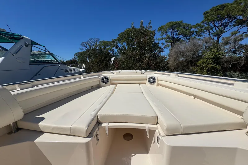 Slide: The Image of 2024 Grady-White Canyon 336 boat interior with beige seating and speakers. - 31