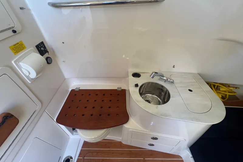 Slide: The Image of 2024 Grady-White Canyon 336 boat interior with sink and wooden seat. - 34