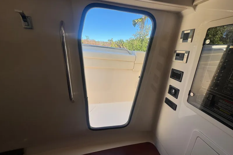 Slide: The Image of Interior view of 2024 Grady-White Canyon 336 boat cabin with open door. - 37