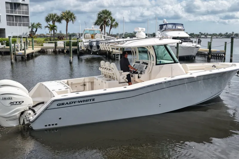 Slide: The Image of 2024 Grady-White Canyon 336 boat docked, featuring Yamaha XTO engines. - 4