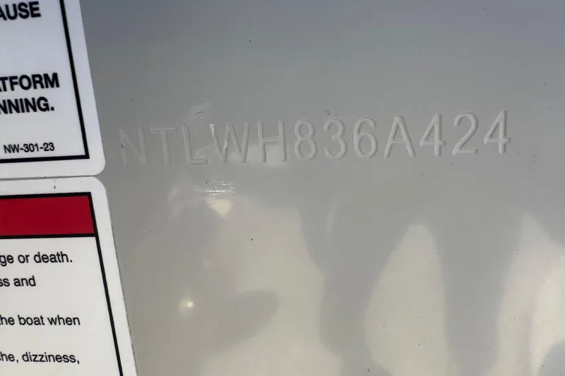 Slide: The Image of 2024 Grady-White Canyon 336 hull identification number and safety warning label. - 43