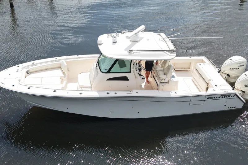 Slide: The Image of 2024 Grady-White Canyon 336 boat on water, featuring dual Yamaha engines. - 7