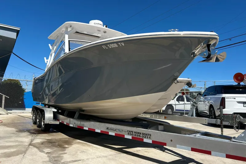 The Image of 2025 Sea Fox 288 Traveler boat on trailer, parked outdoors under clear blue sky. - 0