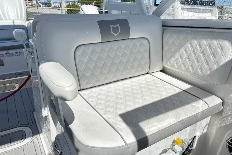 Slide: The Image of 2025 Sea Fox 288 Traveler boat seat with diamond-stitched white upholstery. - 16