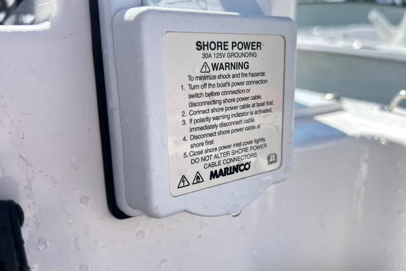 Slide: The Image of Shore power warning label on 2025 Sea Fox 288 Traveler boat. - 19
