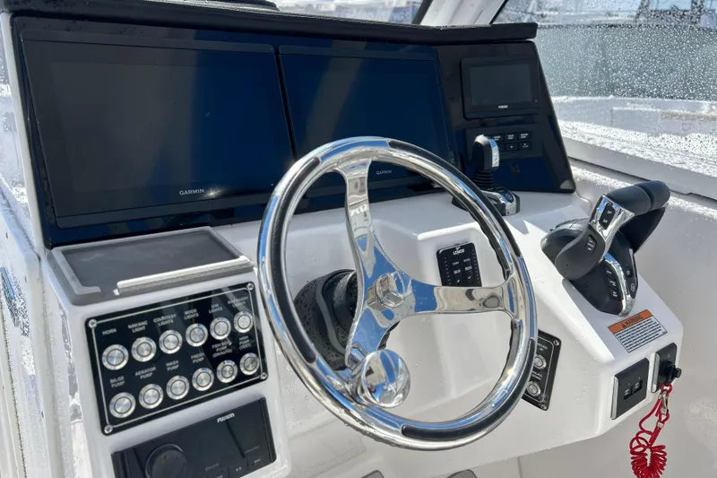 Slide: The Image of 2025 Sea Fox 288 Traveler helm with Garmin displays and modern controls. - 2
