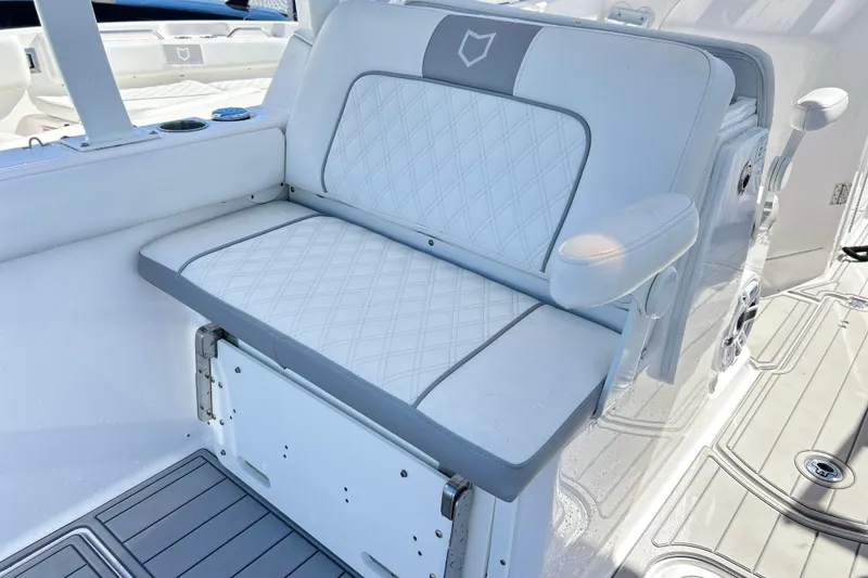 Slide: The Image of 2025 Sea Fox 288 Traveler boat seat with diamond-pattern upholstery and armrest. - 20