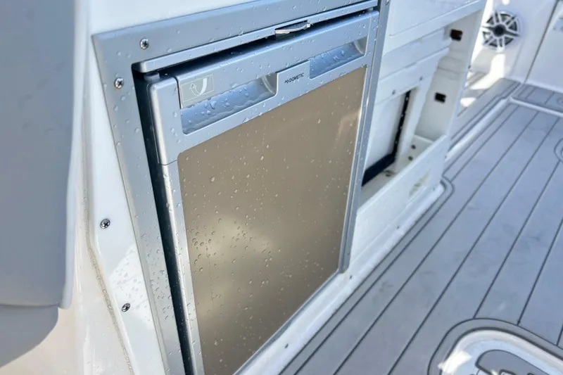 Slide: The Image of Built-in refrigerator on 2025 Sea Fox 288 Traveler boat, featuring sleek design and water droplets. - 23