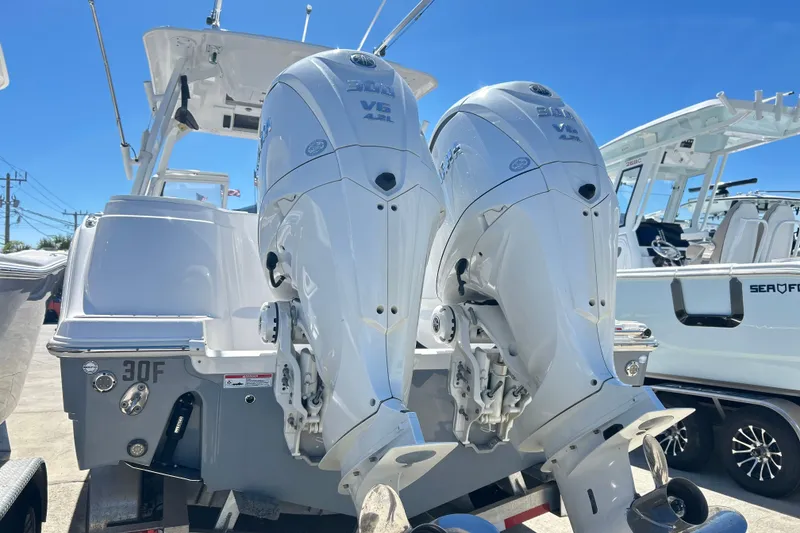 Slide: The Image of 2025 Sea Fox 288 Traveler with dual outboard engines, displayed in a marina setting. - 24