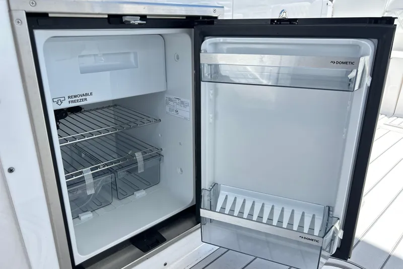 Slide: The Image of Open Dometic refrigerator on 2026 Sea Fox 288 Traveler boat, featuring removable freezer. - 27
