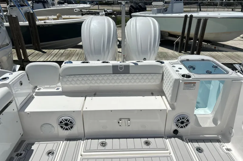 Slide: The Image of 2026 Sea Fox 288 Traveler boat interior with seating and dual engines at dock. - 28