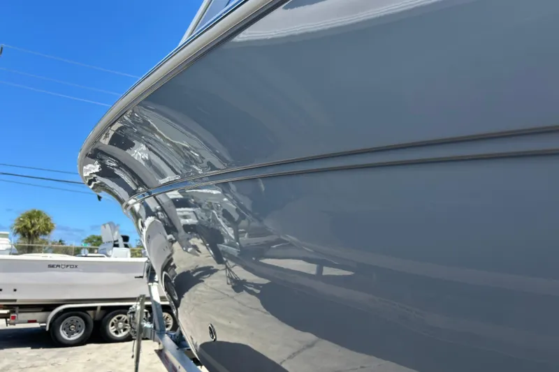 Slide: The Image of 2026 Sea Fox 288 Traveler boat with sleek hull design under clear blue sky. - 32