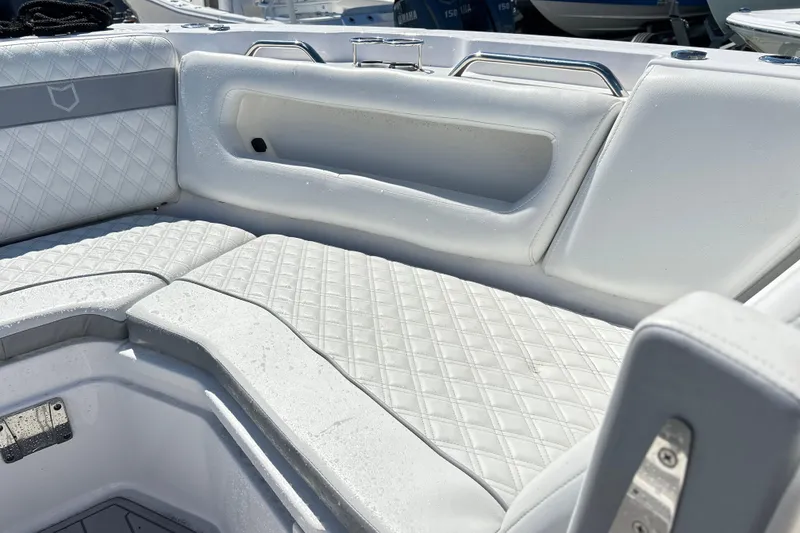 Slide: The Image of 2025 Sea Fox 288 Traveler boat interior with white quilted seating and stainless steel handles. - 8