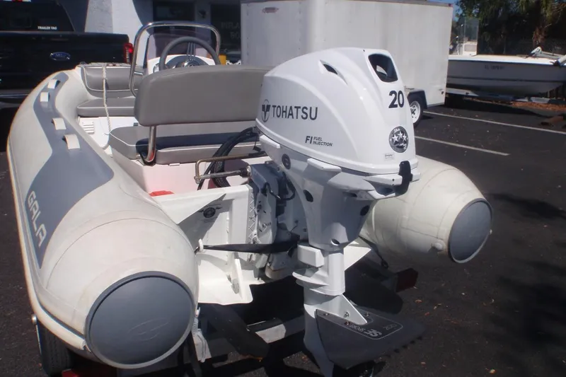 Slide: The Image of Inflatable boat Gala A300L 2021 with Tohatsu outboard motor in parking lot. - 2