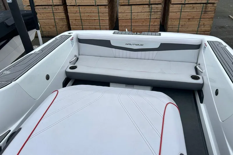 Slide: The Image of 2017 Nautique Ski Nautique 200 Open Bow interior with white seating and cup holders. - 10