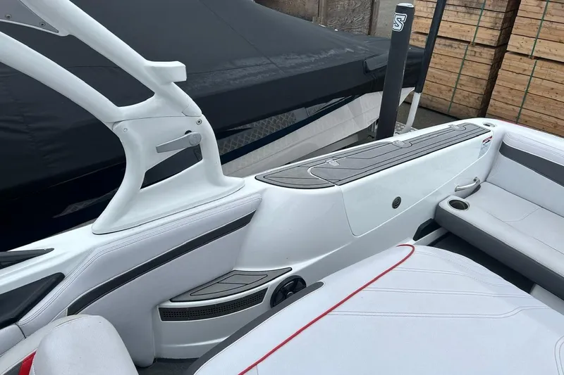 Slide: The Image of 2017 Nautique Ski Nautique 200 Open Bow interior with sleek white seating and modern design. - 11