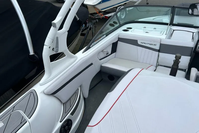 Slide: The Image of 2017 Nautique Ski Nautique 200 Open Bow interior with white and gray seating. - 13