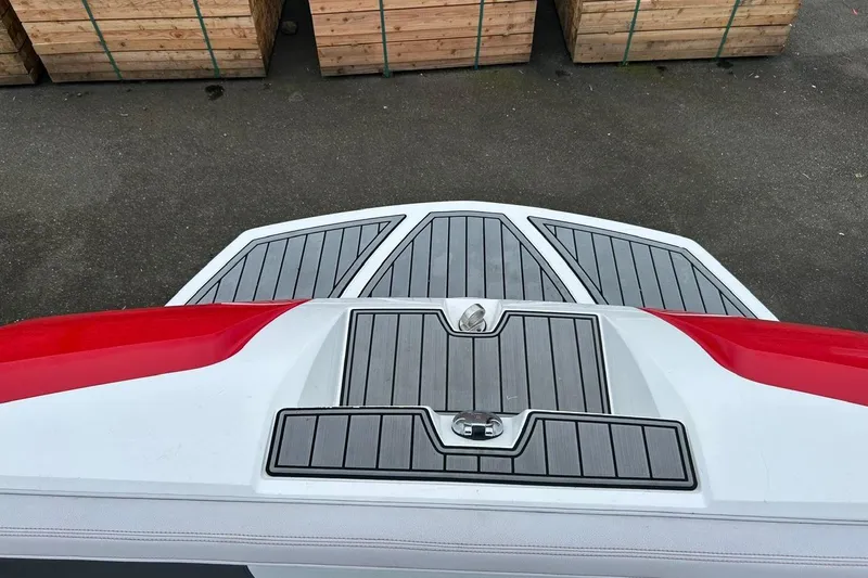 Slide: The Image of 2017 Nautique Ski Nautique 200 Open Bow boat deck with red accents. - 18