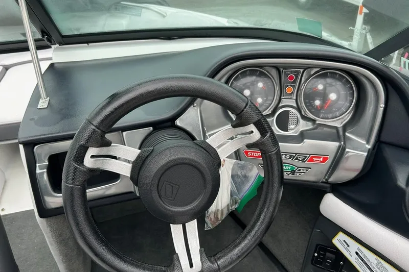 Slide: The Image of 2017 Nautique Ski Nautique 200 Open Bow dashboard with steering wheel and gauges. - 4