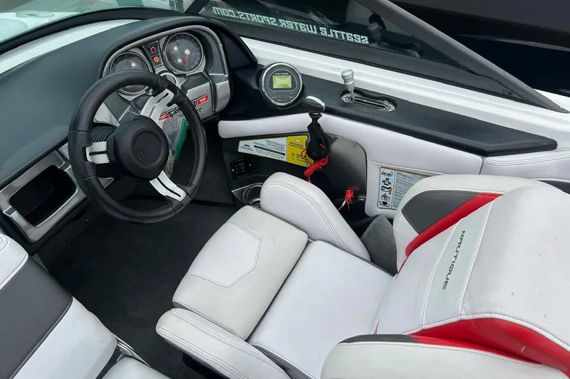 Slide: The Image of 2017 Nautique Ski Nautique 200 Open Bow interior with steering wheel and dashboard controls. - 5