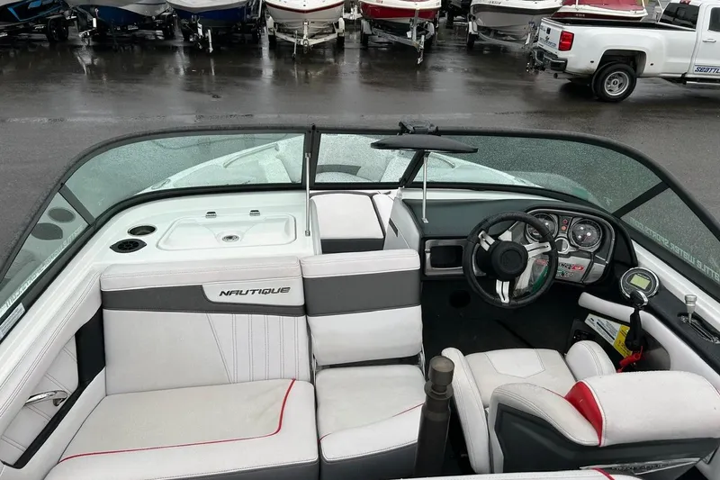Slide: The Image of 2017 Nautique Ski Nautique 200 Open Bow interior with steering wheel and seating. - 7