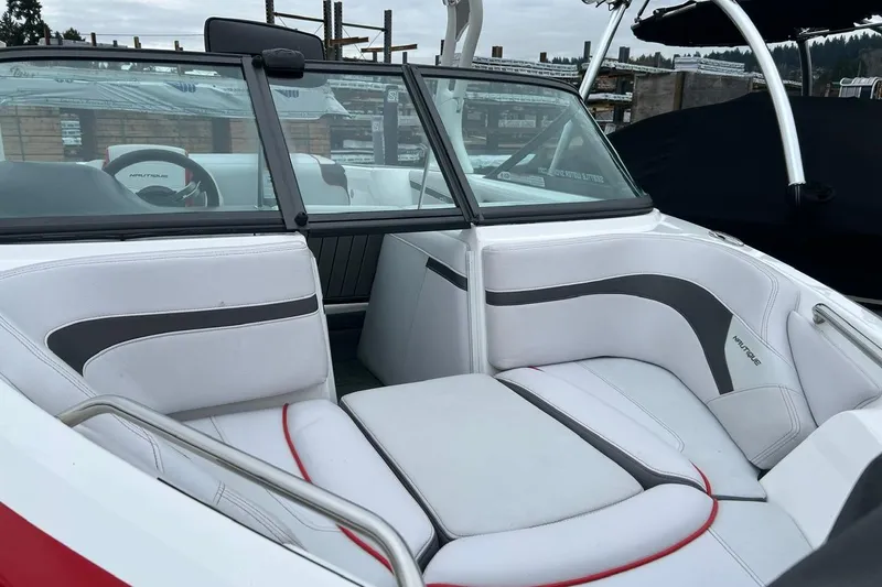 Slide: The Image of 2017 Nautique Ski Nautique 200 Open Bow interior with white and gray seating. - 9
