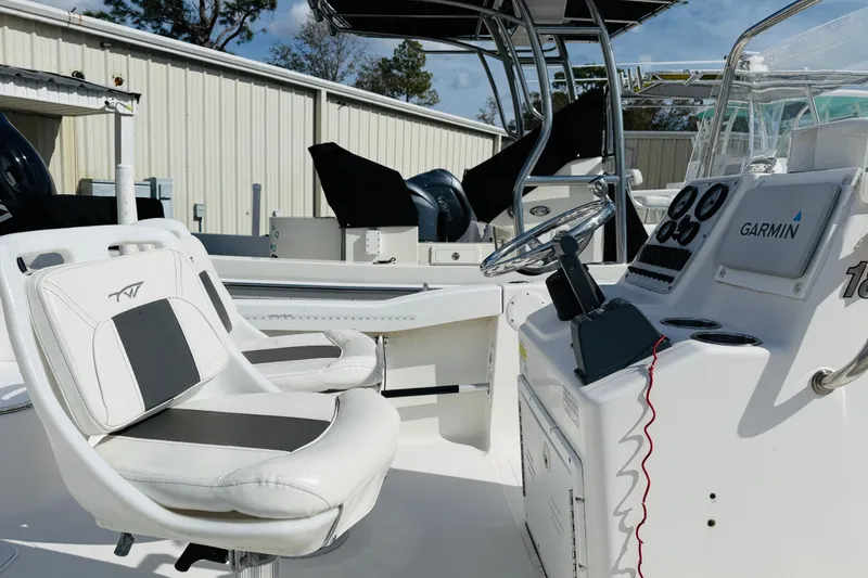 Slide: The Image of 2012 Tidewater 180 CC Adventure boat interior with Garmin navigation system and seating. - 4