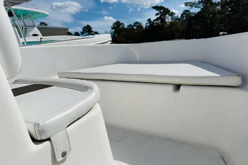 Slide: The Image of 2012 Tidewater 180 CC Adventure boat interior with white seating under blue sky. - 7