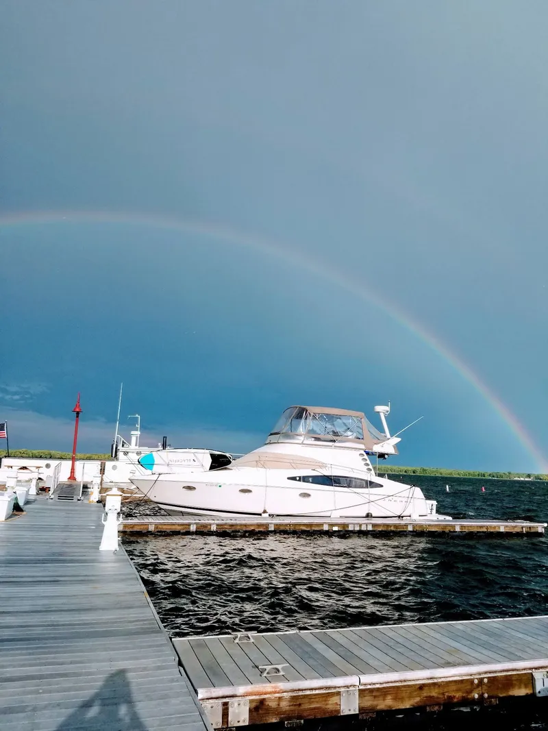 The Image of 2001 Regal 3780 yacht docked under a rainbow. - 0