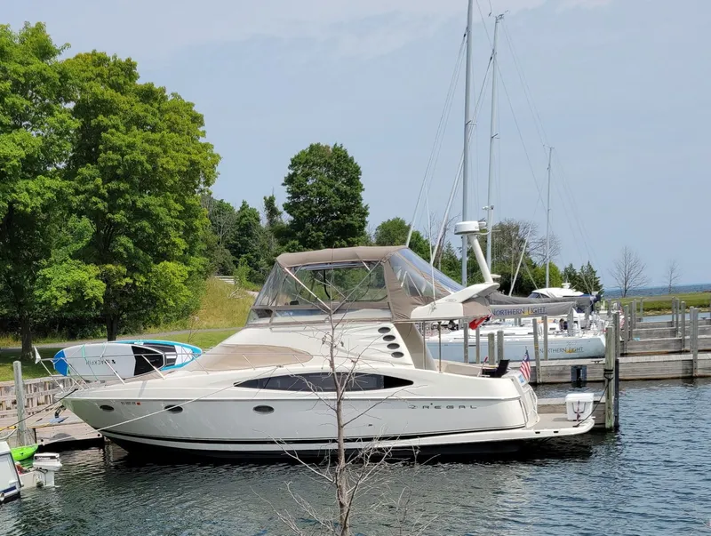 Slide: The Image of 2001 Regal 3780 yacht docked in marina, surrounded by trees. - 2