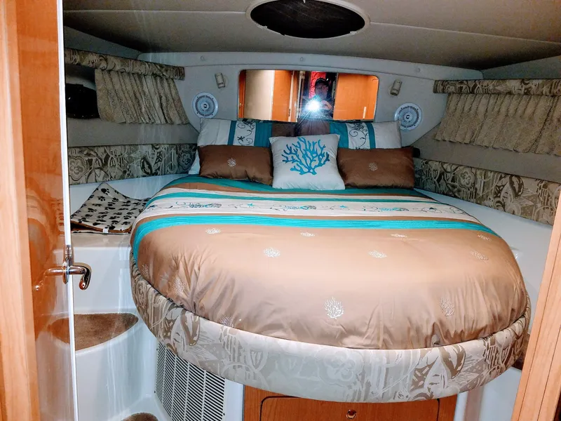 Slide: The Image of Interior of a 2001 Regal 3780 yacht featuring a cozy bedroom. - 4