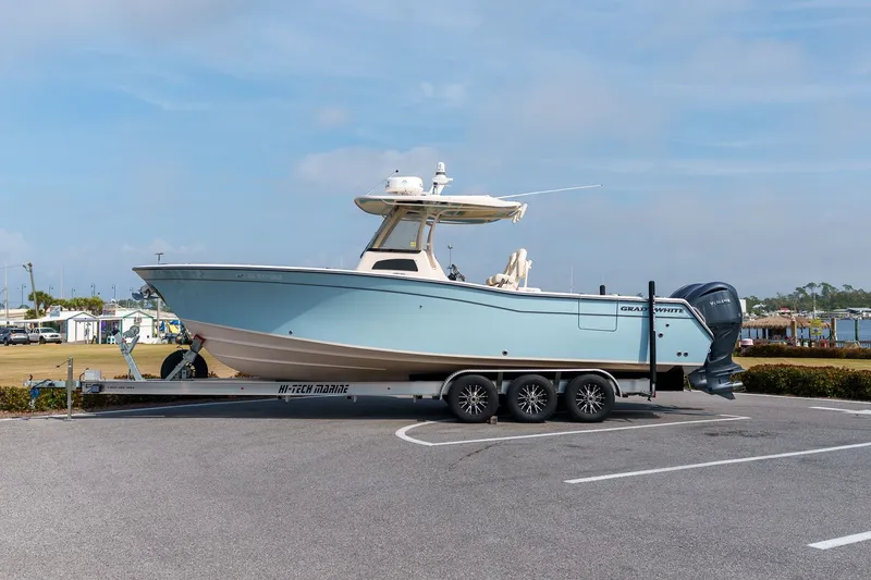 Slide: The Image of 2022 Grady-White Canyon 306 boat parked on trailer outdoors. - 0