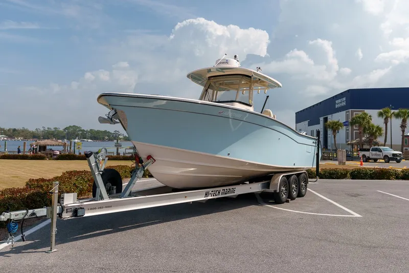 Slide: The Image of 2022 Grady-White Canyon 306 boat on trailer parked outdoors. - 1