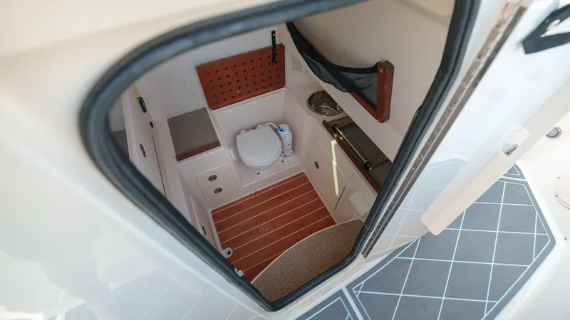 Slide: The Image of Interior of 2022 Grady-White Canyon 306 with toilet and wood flooring. - 12