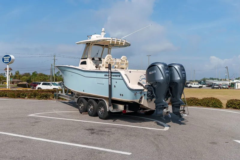 Slide: The Image of 2022 Grady-White Canyon 306 boat on trailer parked at marina. - 2