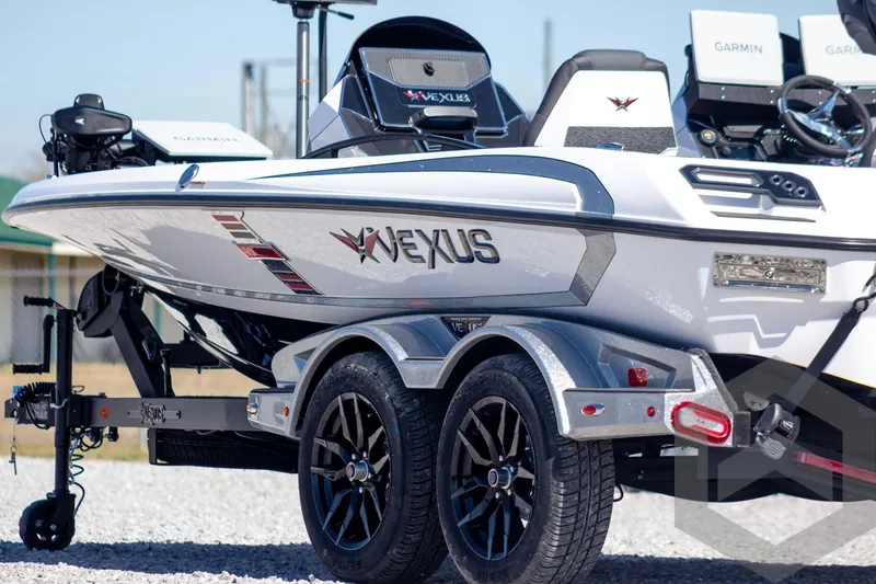 Slide: The Image of 2026 Vexus VXs20 boat on trailer, featuring Garmin electronics and sleek design. - 10