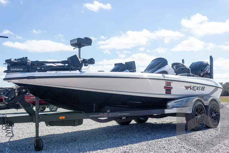 Slide: The Image of 2026 Vexus VXs20 boat on trailer, featuring Garmin equipment, under a clear blue sky. - 11