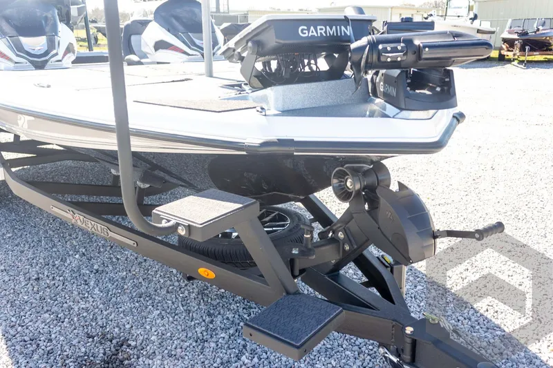 Slide: The Image of 2026 Vexus VXs20 boat with Garmin equipment on a trailer, parked on gravel. - 14