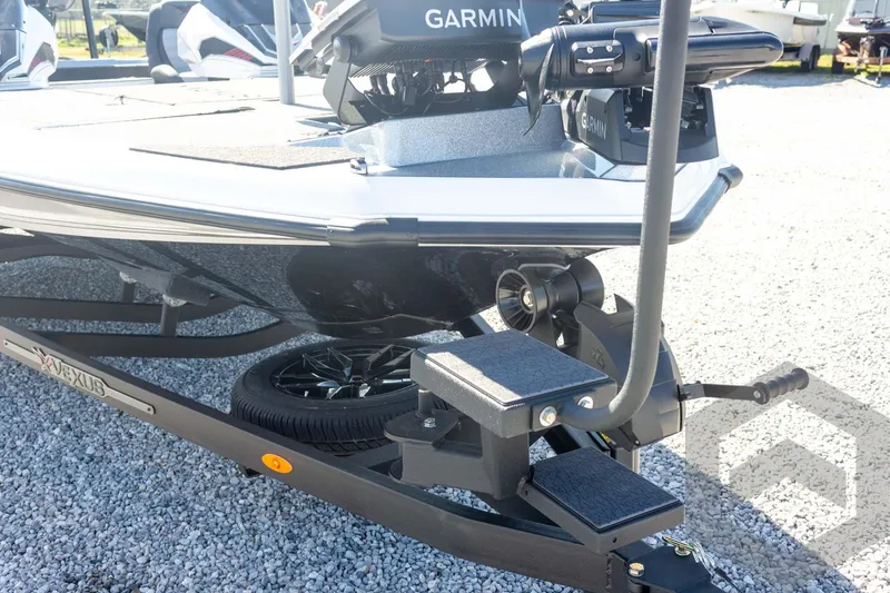 Slide: The Image of 2026 Vexus VXs20 boat with Garmin equipment on a trailer, parked on gravel. - 15